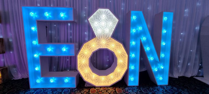 Illuminated engagement ring symbol between two initials