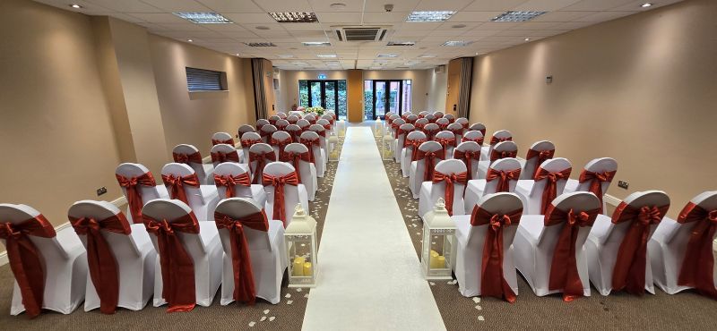 White chair covers with burnt orange satin sash Solihull