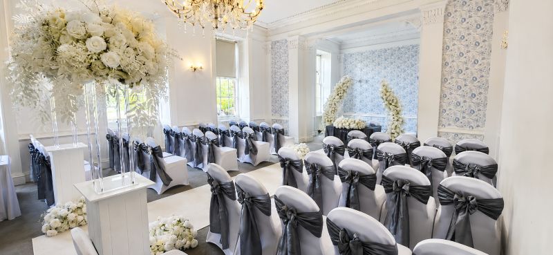 white split flower arches and White chair covers with grey Sash near Birmingham