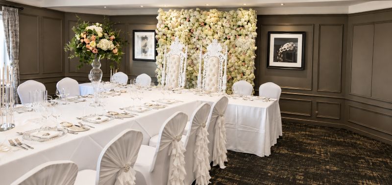 white chair covers with hoods and ruffles and table covers